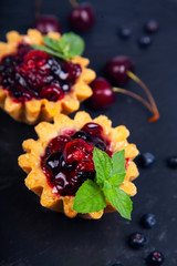 Small berry cake and ripe berries