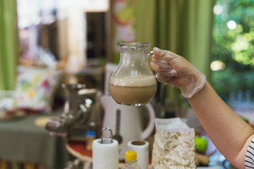 Cook pours boiling water over the yeast to get the mash for the dough. Making dough by diluting yeast with boiling water