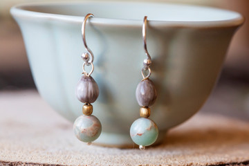 Natural seed and mineral stone little boho earrings hanging on the tea cup