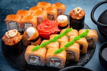 Salmon sushi rolls on round serving board