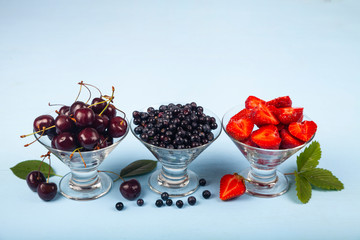 Ripe berries in transparent bowls