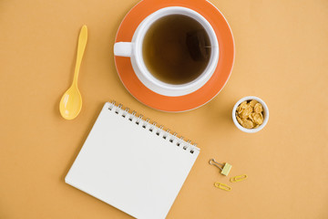 Obraz na płótnie Canvas Top view cup of coffee with notebook