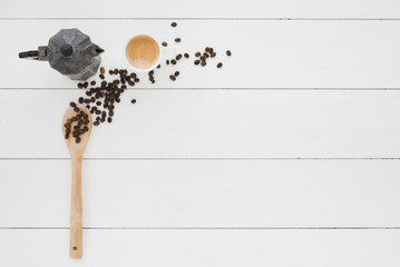 Top view cup of coffee with spoon and grains