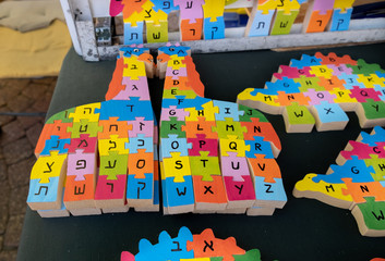 English and hebrew wooden alphabet puzzles looks like animals sold at handicraft market. Tel-Aviv. Israel