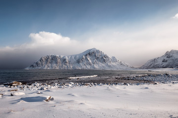 Scenery of snow mountain range with overcast sky in winter