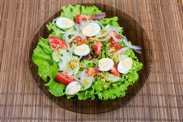 Top view of vegetable salad with boiled quail eggs