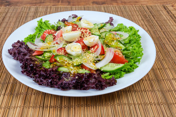 Vegetable salad with boiled quail eggs and with mustard dressing