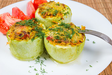 Baked stuffed pieces of vegetable marrow close-up
