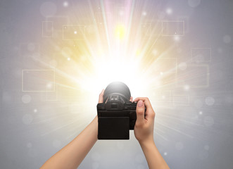 Naked hand taking picture with digital camera and glowing flash concept

