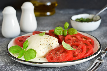Caprese is a classic Italian snack with mozzarella, tomatoes and olive oil.