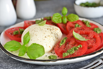 Caprese is a classic Italian snack with mozzarella, tomatoes and olive oil.