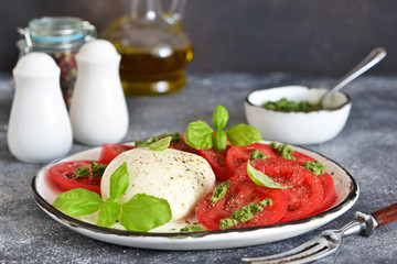 Caprese is a classic Italian snack with mozzarella, tomatoes and olive oil.