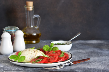 Caprese is a classic Italian snack with mozzarella, tomatoes and olive oil.