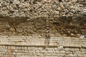 Ancien mur en pierre avec différentes strates historiques.