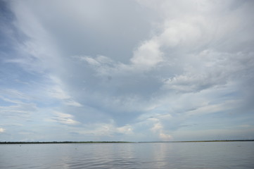 Stormy clouds forming above the Amazon river in the Peruvian rain forest
