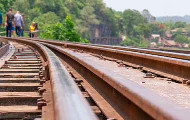 Fototapeta na wymiar People are walking on the railroad tracks