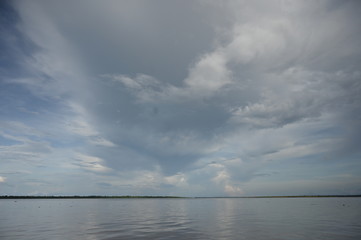 Stormy clouds forming above the Amazon river in the Peruvian rain forest
