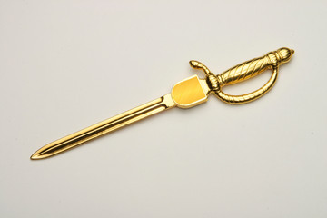Envelope opener made of silver or brass with gold plating.