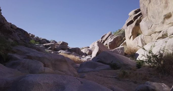 Low angle shot of historic pictographs by Native Americans on rocks and boulders at well known Coyote Hole in Joshua Tree National Park, California.