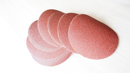 Emery paper in the form of cut circles with a fine abrasive for sanding a wooden surface