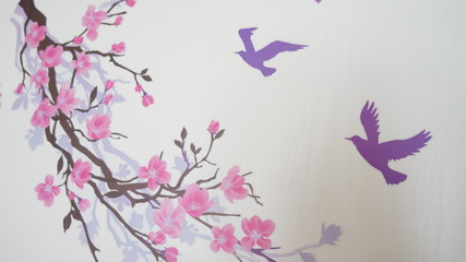 Obraz na płótnie Canvas Graffiti on the wall in the form of a branch of Sakura and blue birds