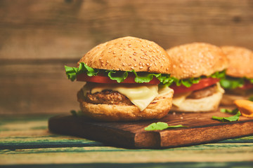 Craft beef burger  on wooden table isolated on black background.