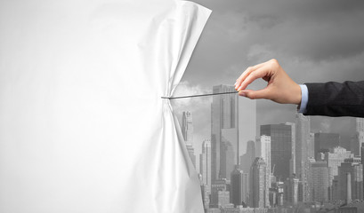 hand pulling green cityscape curtain to gray cityscape, environmental protection concept