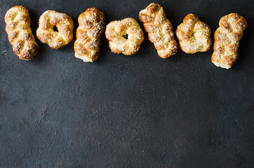 Baked fresh fragrant buns. Traditional homemade pastries. Pigtail buns top view.
