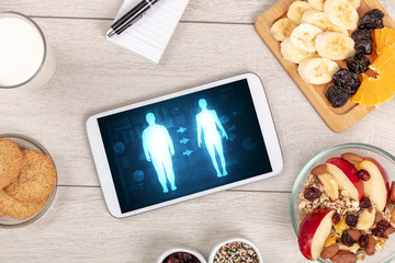 Arrangement of healthy Ingredients with a tablet. Dieting concept