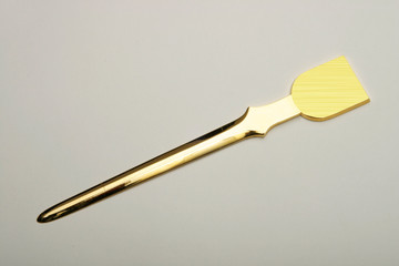 Envelope opener made of silver or brass with gold plating.