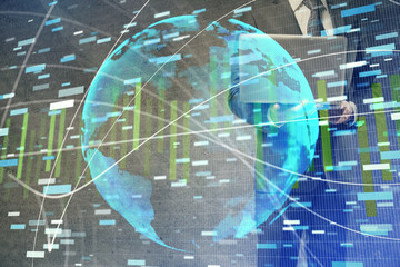Double exposure of businessman working on laptop on background. International business hologram in front. Concept of success.