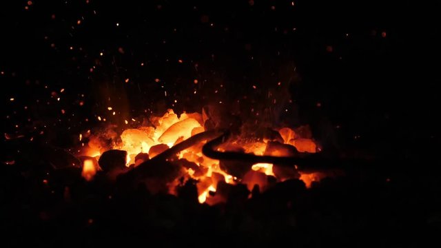 Orange furnace fire with low forks in an old Ukrainian blacksmith workshop 