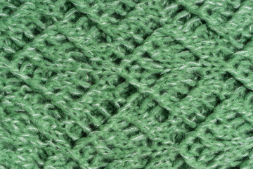 Green knitted woolen sweater texture. Colorful textured background. Horizontal image.