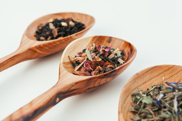leaf  tea in a wooden spoon isolated on white background
