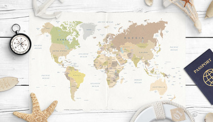 World map, compass, passport and shells. Concept of travel planning. Top view. White wooden desk.