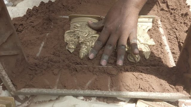 Indian metal workers casting Hindu God and Goddess idols using recycled up-cycled melted metal from everyday objects at a makeshift roadside workshop in India- 4k slow-motion handheld stabilized 
