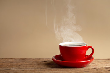 coffee cup on old wooden table with cream wall background.