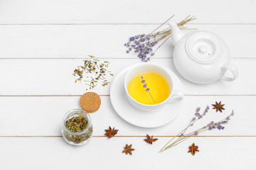 teapot and cups of tea on a white wooden background