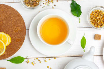 teapot and cups of tea on a white wooden background