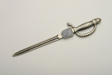 Envelope opener made of silver or brass with gold plating.