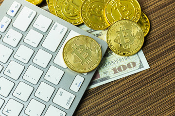 Bitcoin coin on silver keyboard for  cryptocurrency content.