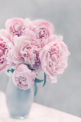 Bouquet of pink peonies in a vase in pastel colors soft focus