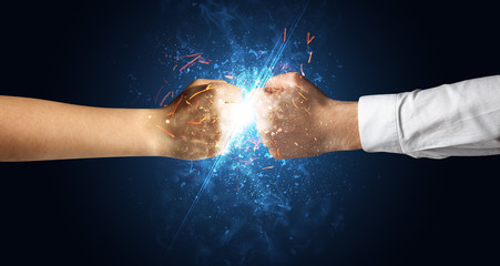 Fototapeta na wymiar Two hands fighting with light, glow, spark and smoke concept 