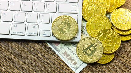 Bitcoin coin on silver keyboard for  cryptocurrency content.