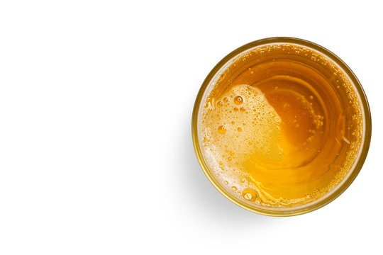 top view of beer bubbles in glass cup on white background. empty space for design.