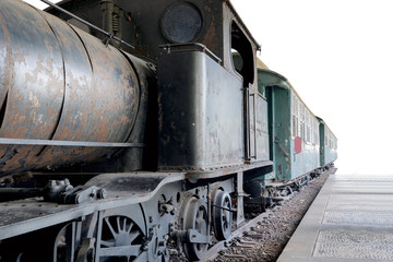 Fototapeta na wymiar Steam locomotive with wagon in a station