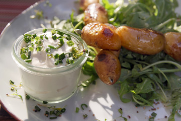 potatoe skewers with sour cream and salad