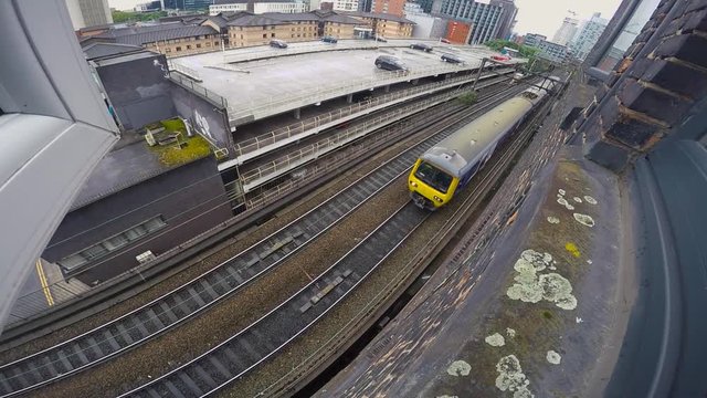 Train travelling past on tracks bellow window