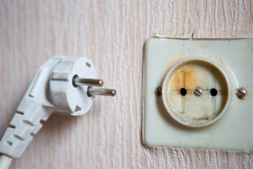 Electricity short circuit. Electrical failure resulting in old electricity socket burnt