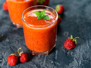 Strawberry red natural homemade smoothie in two glasses on the table